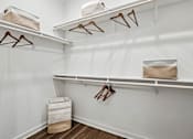 Thumbnail 9 of 20 - Closet with white shelves and hangers.