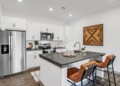 Thumbnail 4 of 56 - a kitchen with a large island and a stainless steel refrigerator at Notch66, Longmont, Colorado