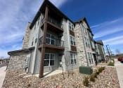 Thumbnail 5 of 88 - an apartment building with stone facade and balconies on a sunny day at The Depot, Missouri