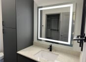 Thumbnail 55 of 88 - a bathroom with a sink and a mirror at The Depot, Raymore, MO, 64083