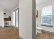 Thumbnail 43 of 58 - an empty bathroom with a toilet and a window at Meridian at CityPlace, Woodbury, 55125