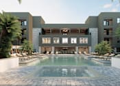 Thumbnail 5 of 21 - A modern building with a pool in front at Refinery at Pointe17 Apartments, Arizona