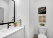 Thumbnail 42 of 58 - a white bathroom with a toilet and a sink at Meridian at CityPlace, Woodbury, MN