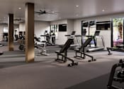 Thumbnail 16 of 35 - A spacious gym with treadmills, elliptical machines, and other exercise equipment.