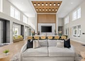 Thumbnail 53 of 58 - a large living room with a gray couch and a table with chairs at Palm Grove in Ellenton, FL 34222