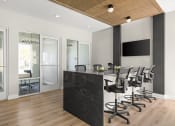 Thumbnail 50 of 58 - a conference room with a black counter and chairs at Palm Grove in Ellenton, FL 34222