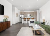 Thumbnail 15 of 58 - a living room with a couch and a coffee table in front of a kitchen at Palm Grove in Ellenton, FL 34222