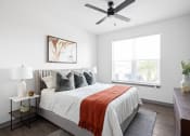Thumbnail 16 of 58 - a bedroom with a bed and a ceiling fan at Palm Grove in Ellenton, FL 34222
