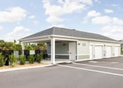 Thumbnail 46 of 58 - the entrance to a parking lot with a pavilion with a black fence at Palm Grove in Ellenton, FL 34222