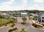 Thumbnail 38 of 58 - an aerial view of a street of houses with palm trees at Palm Grove in Ellenton, FL 34222