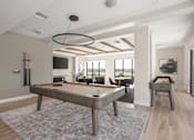 Thumbnail 20 of 60 - A pool table is in the middle of a room with a grey rug.