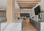 Thumbnail 12 of 60 - A modern kitchen with wooden floors and a marble countertop.