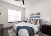 Thumbnail 24 of 60 - A bedroom with a bed, pillows, a ceiling fan, and two wall art pieces.