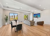 Thumbnail 45 of 60 - A modern living room with a dining table and chairs.