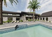 Thumbnail 7 of 31 - A pool in front of a building with palm trees.