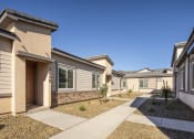 Thumbnail 7 of 68 - a row of townhomes with a sidewalk in front of them at Grandstone at Sunrise, Peoria, AZ