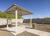 Thumbnail 45 of 68 - a pavilion with a bench and a trash can at Grandstone at Sunrise, Peoria, AZ