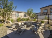 Thumbnail 53 of 68 - an outdoor patio with chairs and a fire pit at Grandstone at Sunrise, Peoria, AZ