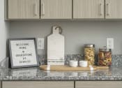 Thumbnail 64 of 68 - a kitchen counter with a sign that reads welcome home and gratitude at sunset at Grandstone at Sunrise, Peoria, AZ