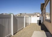 Thumbnail 61 of 68 - a white fence in a backyard next to a house at Grandstone at Sunrise, Peoria, AZ