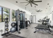 Thumbnail 67 of 68 - a gym with weights and a ceiling fan at Grandstone at Sunrise, Peoria, AZ