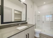 Thumbnail 37 of 46 - a bathroom with a large mirror and a toilet and a shower at Alta25, Monument, Colorado