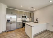 Thumbnail 33 of 46 - a kitchen with stainless steel appliances and a white counter top at Alta25, Monument, Colorado