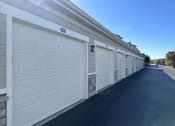Thumbnail 48 of 56 - a row of white garage doors on a building at Watermark at Steele Crossing, Arkansas, 72703
