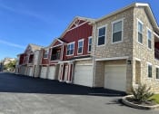 Thumbnail 49 of 56 - a row of brick houses with white garage doors at Watermark at Steele Crossing, Arkansas, 72703