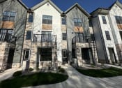 Thumbnail 4 of 45 - an exterior view of a building with stone and wood accents at The BLVD at Wilson Crossings, Wyoming