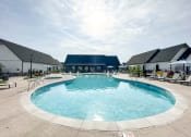Thumbnail 3 of 45 - a swimming pool at the resort on a sunny day at The BLVD at Wilson Crossings, Wyoming, MI 49418