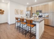 Thumbnail 4 of 58 - a kitchen with a island with four stools in front of it  at Palm Grove, Ellenton, FL, 34222