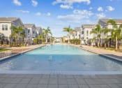 Thumbnail 21 of 58 - a large swimming pool with houses in the background  at Palm Grove, Florida