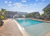 Thumbnail 3 of 58 - a swimming pool with a fountain in front of a house  at Palm Grove, Ellenton, Florida