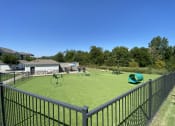 Thumbnail 3 of 56 - a fenced turf pet park with dog agilities  at Watermark at Steele Crossing, Fayetteville, Arkansas