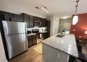 Thumbnail 45 of 56 - a kitchen with stainless steel appliances and granite counter tops at Watermark at Steele Crossing, Fayetteville, 72703