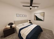 Thumbnail 9 of 21 - A bedroom with a bed, nightstand, and ceiling fan.