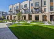 Thumbnail 1 of 58 - a view of the exterior of a building with green grass at Meridian at CityPlace in Woodbury, 55125