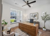 Thumbnail 8 of 58 - a living room with a desk and a ceiling fan at Meridian at CityPlace, Woodbury, MN