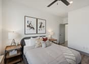 Thumbnail 30 of 58 - a bedroom with a large bed and a ceiling fan at Meridian at CityPlace, Woodbury, MN