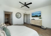 Thumbnail 13 of 58 - a bedroom with a bed and a ceiling fan at Meridian at CityPlace, Woodbury, Minnesota 55125