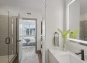 Thumbnail 12 of 58 - a white bathroom with a shower and a sink at Meridian at CityPlace, Woodbury, MN