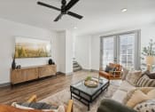 Thumbnail 6 of 58 - a living room with a ceiling fan and a couch at Meridian at CityPlace, Woodbury, MN 55125