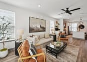 Thumbnail 4 of 58 - a living room with a ceiling fan and a couch at Meridian at CityPlace, Woodbury, Minnesota
