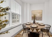 Thumbnail 45 of 58 - a dining room with a table and chairs and a large window at Meridian at CityPlace, Woodbury, MN 55125