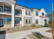 Thumbnail 2 of 40 - an exterior view of three buildings with a sidewalk in front of them at Stella, San Tan Valley, AZ