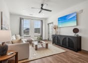 Thumbnail 12 of 40 - an open living room with a fireplace and a ceiling fan at Stella, San Tan Valley, AZ 85143