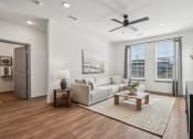Thumbnail 3 of 40 - a living room with a couch and a ceiling fan  at Stella Luxury Apartment Homes, San Tan Valley, AZ
