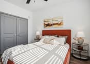 Thumbnail 32 of 40 - a bedroom with a bed and two lamps and a closet at Stella Luxury Apartment Homes, San Tan Valley