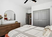 Thumbnail 9 of 11 - A bedroom with a bed, dresser, mirror, and ceiling fan at The Pullman Luxury Apartment Homes, Atlanta